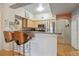 Open kitchen with granite countertops and breakfast bar overlooking the living area at 100 4Th S Ave # 103, St Petersburg, FL 33701