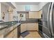 Modern kitchen with granite countertops, stainless steel appliances, and light wood cabinets at 100 4Th S Ave # 103, St Petersburg, FL 33701
