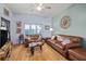 Cozy living room featuring leather furniture, hardwood floors, and a bright window at 100 4Th S Ave # 103, St Petersburg, FL 33701