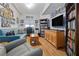 Well-lit living room with wood-look floors, a comfortable sofa, and built-in bookshelves at 100 4Th S Ave # 103, St Petersburg, FL 33701