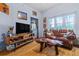 Comfortable living room with hardwood floors, a leather sofa, and entertainment center at 100 4Th S Ave # 103, St Petersburg, FL 33701