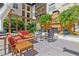 A patio area with outdoor furniture, pavers, and tropical greenery at 100 4Th S Ave # 103, St Petersburg, FL 33701