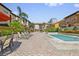 Community pool featuring lounge chairs and a paved deck with a nearby grilling area at 100 4Th S Ave # 103, St Petersburg, FL 33701