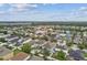Expansive aerial view of a neighborhood with well-maintained homes and lush landscaping at 11541 Tangle Branch Ln, Gibsonton, FL 33534