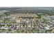 Aerial view of a Primary-planned community, showcasing diverse home styles, lush landscaping, and a peaceful waterway at 11541 Tangle Branch Ln, Gibsonton, FL 33534