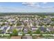 High-angle shot showcasing many homes, manicured lawns, tree-lined streets in community at 11541 Tangle Branch Ln, Gibsonton, FL 33534