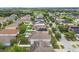 Overhead view of a neighborhood showcasing homes with solar panels and green yards at 11541 Tangle Branch Ln, Gibsonton, FL 33534
