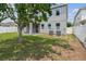 Well-maintained backyard with a covered patio area and white privacy fence at 11541 Tangle Branch Ln, Gibsonton, FL 33534