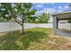 Fenced backyard with grass and a tree, offering privacy and space at 11541 Tangle Branch Ln, Gibsonton, FL 33534