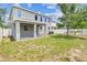 Backyard features a patio area and a green lawn, enclosed by a white fence at 11541 Tangle Branch Ln, Gibsonton, FL 33534