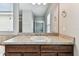 Bathroom vanity with a sink and a large mirror that shows an open doorway and bedroom at 11541 Tangle Branch Ln, Gibsonton, FL 33534