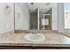 Bathroom vanity with a sink and a large mirror with an additional view of the walk-in shower at 11541 Tangle Branch Ln, Gibsonton, FL 33534