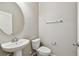 Bright bathroom with pedestal sink, chrome hardware, and a modern toilet at 11541 Tangle Branch Ln, Gibsonton, FL 33534