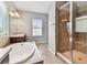 Bathroom with a large tub and shower with tile surround at 11541 Tangle Branch Ln, Gibsonton, FL 33534