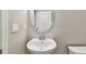 Stylish bathroom vanity featuring a round mirror and contemporary fixtures at 11541 Tangle Branch Ln, Gibsonton, FL 33534