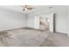 Spacious primary bedroom with an open doorway to a secondary living space at 11541 Tangle Branch Ln, Gibsonton, FL 33534