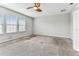 A bright bedroom with a ceiling fan and three windows at 11541 Tangle Branch Ln, Gibsonton, FL 33534