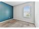 Bedroom with soft carpeting, a window providing natural light, and a vibrant accent wall at 11541 Tangle Branch Ln, Gibsonton, FL 33534