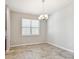 Bright dining area illuminated by chandelier, complemented by tile floors at 11541 Tangle Branch Ln, Gibsonton, FL 33534