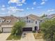 Charming home featuring a two-car garage, well-kept lawn, and inviting entrance at 11541 Tangle Branch Ln, Gibsonton, FL 33534
