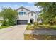 Charming two-story home featuring a well-manicured lawn and a two-car garage at 11541 Tangle Branch Ln, Gibsonton, FL 33534