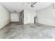 Clean, unfinished garage featuring concrete floor and a new water heater at 11541 Tangle Branch Ln, Gibsonton, FL 33534