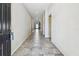 Long hallway with tile floors leading to a bright, open space at 11541 Tangle Branch Ln, Gibsonton, FL 33534