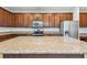 Open kitchen with large island, stainless steel appliances, granite counters and dark wood cabinets at 11541 Tangle Branch Ln, Gibsonton, FL 33534
