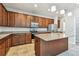 Large kitchen features stainless steel appliances, wooden cabinets, granite countertops, and tile flooring at 11541 Tangle Branch Ln, Gibsonton, FL 33534