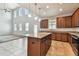 Modern kitchen featuring a central island, pendant lights, and stainless steel appliances at 11541 Tangle Branch Ln, Gibsonton, FL 33534