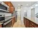 Well-equipped kitchen features stainless steel appliances, granite countertops, and tile flooring at 11541 Tangle Branch Ln, Gibsonton, FL 33534