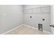 A basic laundry room area with tile flooring and simple shelving at 11541 Tangle Branch Ln, Gibsonton, FL 33534