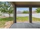 Covered patio with concrete floor looking out onto a spacious backyard and white fence at 11541 Tangle Branch Ln, Gibsonton, FL 33534