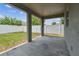 View of the backyard and fence from a covered patio with concrete flooring at 11541 Tangle Branch Ln, Gibsonton, FL 33534