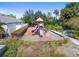 Community playground with modern equipment, benches, and mature trees at 11541 Tangle Branch Ln, Gibsonton, FL 33534