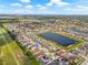 Aerial view of a lakeside residential community with single-Gathering homes and scenic water views at 11551 Brighton Knoll Loop, Riverview, FL 33579