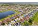 Residential neighborhood with homes, green spaces, and a pond. Houses have fences and solar panels at 11551 Brighton Knoll Loop, Riverview, FL 33579