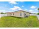 Well-maintained backyard with a fenced perimeter, green grass, and exterior of the single-Gathering home at 11551 Brighton Knoll Loop, Riverview, FL 33579