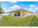 The backyard features a covered patio, grill, and lush grass, perfect for outdoor gatherings and relaxation at 11551 Brighton Knoll Loop, Riverview, FL 33579