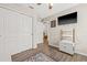 Bonus room with TV, custom cabinet, closet, and wood-look flooring at 11551 Brighton Knoll Loop, Riverview, FL 33579