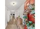 Inviting foyer with a decorative wreath on the red front door, complemented by wood-look floors and recessed lighting at 11551 Brighton Knoll Loop, Riverview, FL 33579