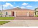 Beautiful single-story home featuring a three-car garage, brick driveway, and well-maintained landscaping at 11551 Brighton Knoll Loop, Riverview, FL 33579