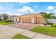 Charming single-story home with a brick driveway, manicured lawn, and a spacious three-car garage at 11551 Brighton Knoll Loop, Riverview, FL 33579
