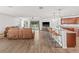 Open-concept living room and kitchen featuring modern finishes, a breakfast bar, and access to outdoor space at 11551 Brighton Knoll Loop, Riverview, FL 33579