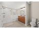 Bathroom featuring separate tiled shower and tub, wood cabinets, and neutral tile floors at 11551 Brighton Knoll Loop, Riverview, FL 33579