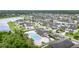 Community aerial view showcasing pool, cabana, landscaping, and residential homes near a pond at 11918 Winterset Cove Dr, Riverview, FL 33579