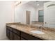 Bathroom featuring a double vanity with granite countertops and dark wood cabinets at 11918 Winterset Cove Dr, Riverview, FL 33579