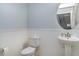 Powder room features a pedestal sink, round mirror and bead board at 11918 Winterset Cove Dr, Riverview, FL 33579