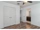 Bright bedroom features wood-look floors, closet, and doorway to a bathroom at 11918 Winterset Cove Dr, Riverview, FL 33579
