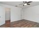 Bright bedroom features wood-look floors, ceiling fan and walk-in closet at 11918 Winterset Cove Dr, Riverview, FL 33579